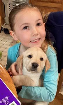 A child holding a dog

Description automatically generated with medium confidence